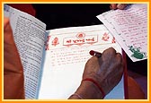 Swamishri writes his blessings in the mandir account book 