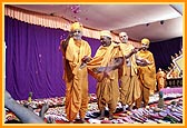Swamishri showers sanctified flower petals on the account books 