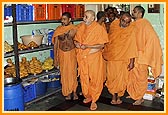 Swamishri sanctifies the Annakut food items in the store room