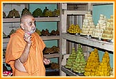 Swamishri sanctifies the Annakut food items in the store room