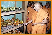 Swamishri sanctifies the Annakut food items in the store room