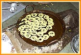 Swamishri showers flower petals and sanctifies the jalebi for Annakut prasad 