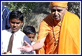 Swamishri throws a ball at a boy