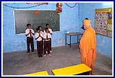 Swamishri listens to the children's welcome song at the school