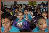 Shibir participants pray before start of a session