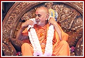 Swamishri is honored with beautiful garlands