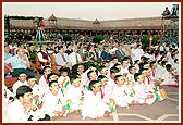 Invited guests and children are absorbed in the stage program 