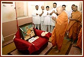 Swamishri engaged in darshan at Yogiji Maharaj's room prior to his morning puja