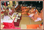 Swamishri rocks Shri Harikrishna Maharaj in the cradle to celebrate the birth of Bhagwan Swaminarayan