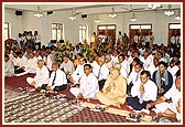 Devotees engaged in the murti-pratishtha rituals