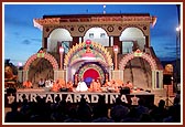 Sadhus perform kirtan aradhana on the beautifully lit up stage by the mandir steps