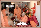 Swamishri serves dhudhpak to Doctor Swami on the occasion of Shastrji Maharaj's shraddh