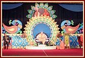 Swamishri and senior sadhus seated on stage during a Satsang assembly