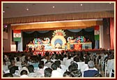 Swamishri and senior sadhus seated on stage during a Satsang assembly