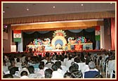 Swamishri and senior sadhus seated on stage during a Satsang assembly