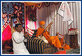 Swamishri waves a flag during the cultural program performed to commemorate the BAPS Centenary celebrations