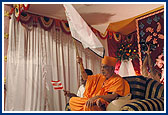 Swamishri waves a flag during the cultural program performed to commemorate the BAPS Centenary celebrations