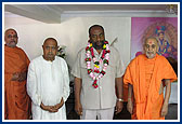 The Home Minister of Uganda, Dr. Rugunda, with Swamishri after welcoming him 