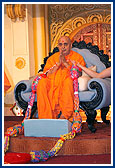 Swamishri was honored with garlands and decorated shawls