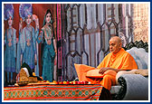 Swamishri's morning puja with a backdrop of murtis and three shrines of Bochasan Mandir