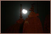 The eclipse visible amongst the pinnacles of Shri Swaminarayan Mandir, London