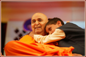 A young child shows his love for Swamishri