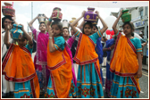 Young girls take part in the Rath Yatra wearing colourful saris