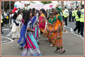 Girls dressed in traditional outfits dance in the Rath Yatra