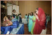 Young Yuvatis offer their devotion to Harikrishna Maharaj in the Tula