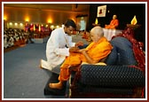 Swamishri presented with the ID badge of the Shibir