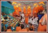 Swamishri rocks Harikrishna Maharaj on the hindolo decorated with an Annakut prepared by the Kishori Mandal