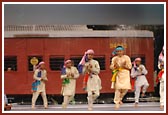 Children performing dances during the train journey