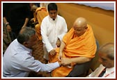 Sadhus tying rakhdis on devotees wrists