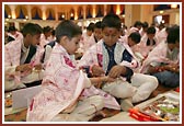 Balaks participating in the mahapuja tie nada-chadi on each other