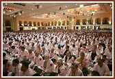 Mahapuja participants fold their hands in prayer