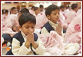 A young child is lost in prayer