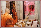 Swamishri lovingly performs darshan of Ghanshyam Maharaj inside a replica of the Akshar Deri
