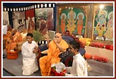 Swamishri opens the newly-released Suvarna Smruti DVD