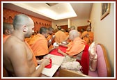 Swamishri serving prasad to the sadhus
