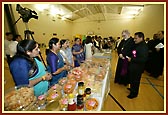 The Archbishop being shown the various items prepared by ladies volunteers in SAYA