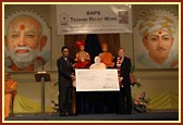 Rt. Hon. Charles Kennedy MP presents the BAPS cheque to Mr Zainal Abidin Ahmad, Deputy High Commissioner for Malaysia