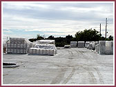 Carved stones from India on new parking lot for storage