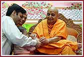  Swamishri lovingly blesses a child after morning pooja


