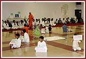  Balaks hold up signs of quotations from scriptures during Swamishri's walk