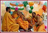 Swamishri is presented with a garland of candies made by balikas