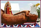 Shri Ghanshyam Maharaj seated on an Eagle float