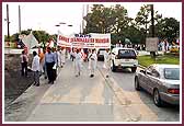 Devotees proudly wave banners during the procession