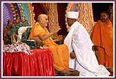 Swamishri applies chandan to the foreheads of initiates
