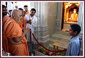 Swamishri talks to a balak after having darshan of Brahmswarup Shastriji Maharaj  