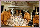 Swamishri is offered one of three quilts made by the combined effort of 450 yuvatis